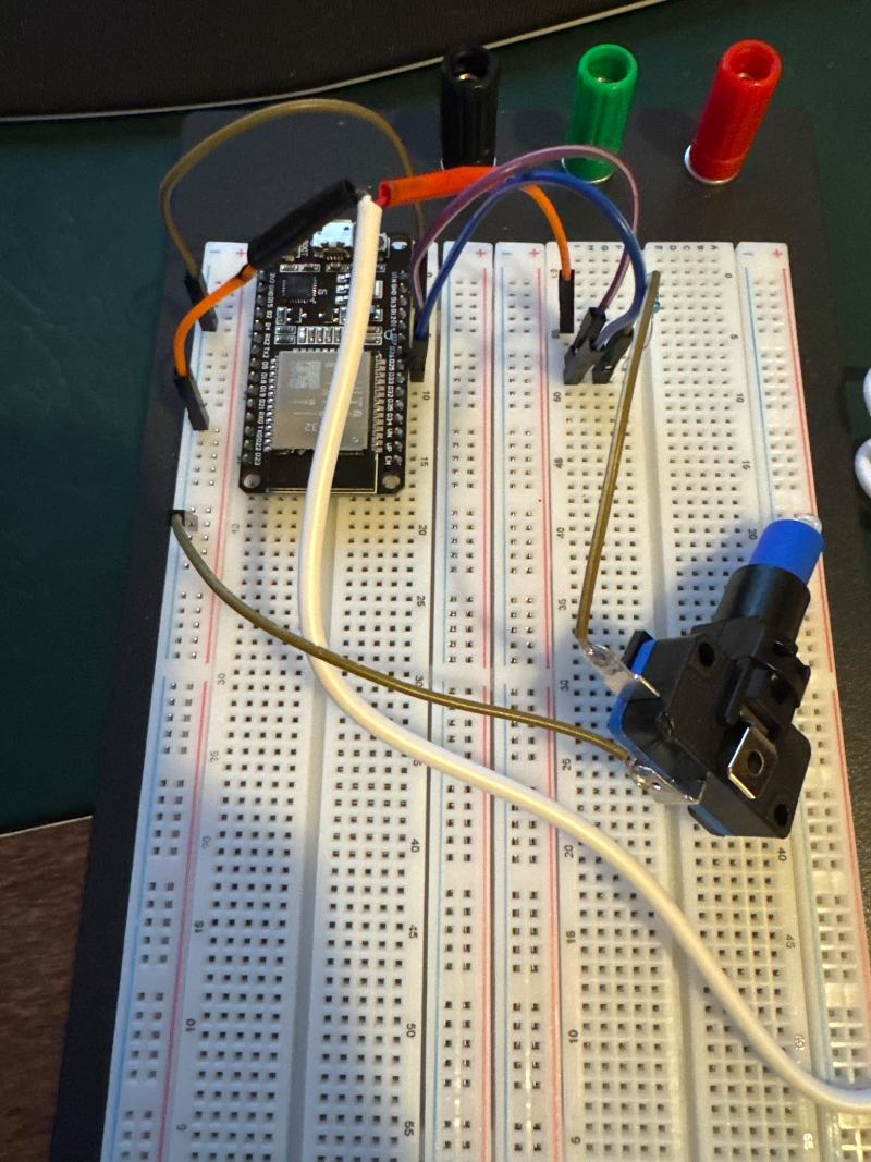 Microcontroller and a switch wired up on a breadboard